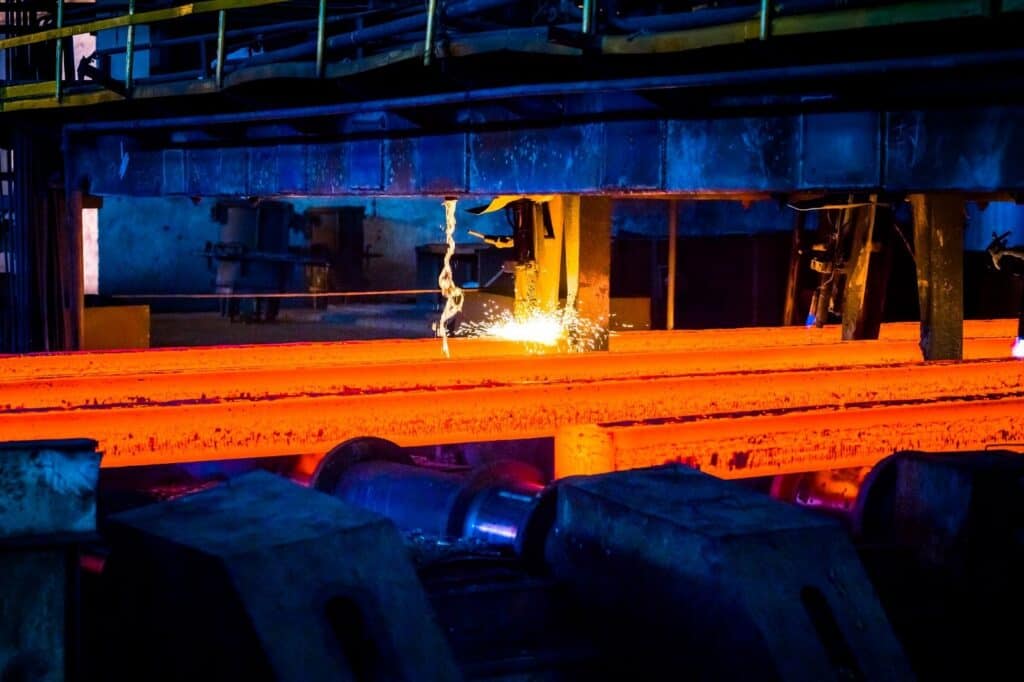 Molten steel slabs undergoing high-temperature processing, highlighting oxidation challenges in heat resistant stainless steel.